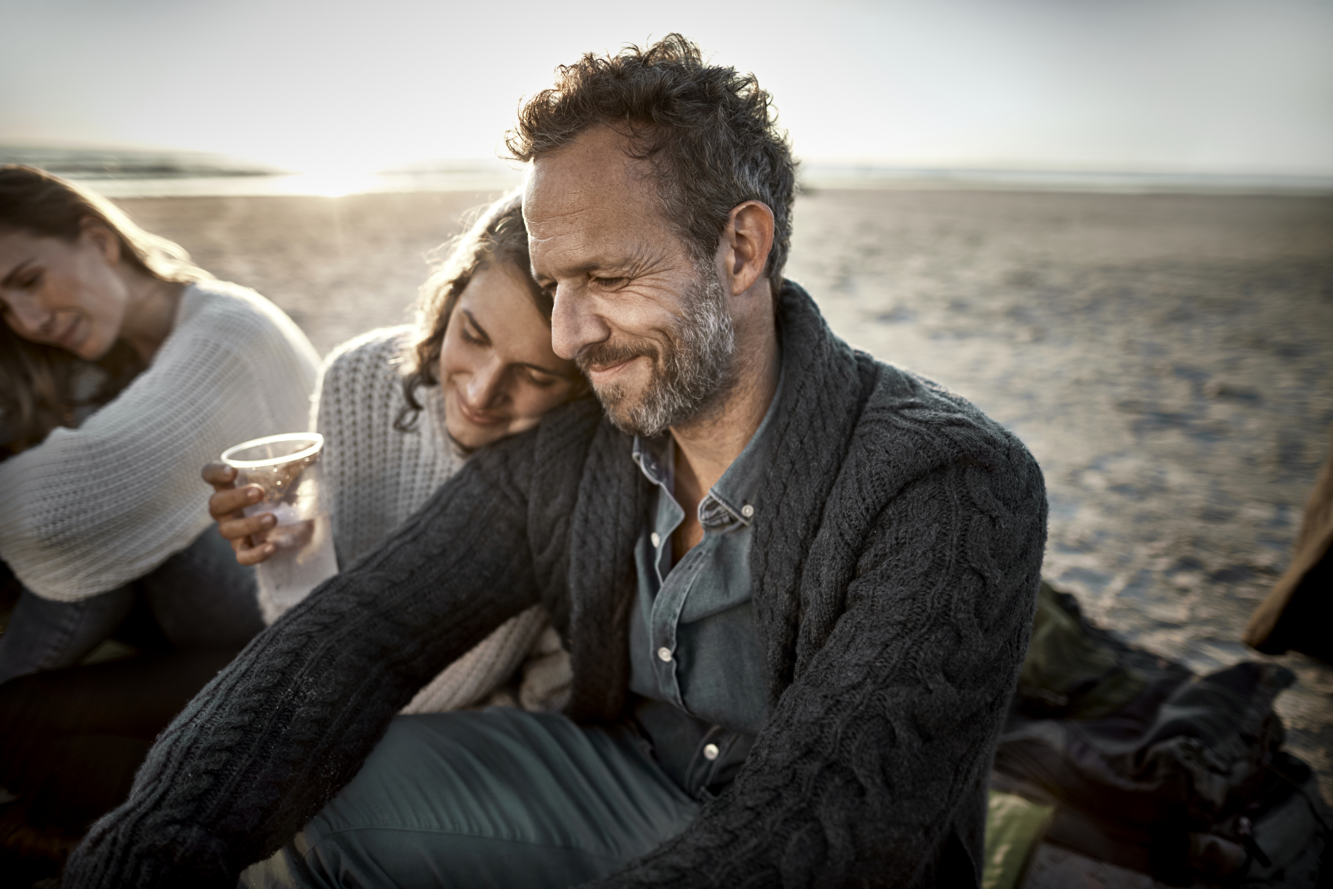 Couple enjoying drink on the beach